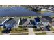 Aerial view of a house near a lake in a neighborhood with well-maintained lawns at 1524 Venice Ln, Davenport, FL 33896