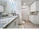 Bathroom showcasing granite countertops, white cabinets, and plenty of storage space at 1524 Venice Ln, Davenport, FL 33896