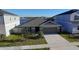 Charming single-Gathering home featuring a well-manicured lawn, two-car garage, and view of the lake at 1524 Venice Ln, Davenport, FL 33896