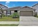 Charming single-story home featuring a two-car garage and well-manicured front yard at 1524 Venice Ln, Davenport, FL 33896
