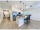 Modern kitchen features white cabinets, stainless steel appliances, and a granite island at 1524 Venice Ln, Davenport, FL 33896