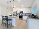 Well-lit kitchen with island, stainless appliances, white cabinets, and granite counters at 1524 Venice Ln, Davenport, FL 33896