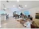Open-concept living room with wood-look floors, modern furnishings, and plenty of natural light at 1524 Venice Ln, Davenport, FL 33896