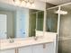Bathroom featuring double sinks, modern fixtures, and a glass-enclosed shower at 1613 Pelican Dr, Davenport, FL 33896