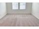 Simple carpeted bedroom with a window and minimal decor at 1613 Pelican Dr, Davenport, FL 33896