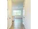 Bright foyer with tile flooring, white doors and trim, and a view into the living spaces at 1613 Pelican Dr, Davenport, FL 33896