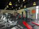 Spacious fitness center with modern exercise equipment and vibrant wall art at 1613 Pelican Dr, Davenport, FL 33896