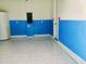 This garage has a blue and white paint scheme and a modern tiled floor for convenience at 1613 Pelican Dr, Davenport, FL 33896