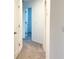 Neutral hallway showing multiple doors and access to other areas of the home at 1613 Pelican Dr, Davenport, FL 33896