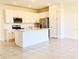 Light and airy kitchen featuring a center island, stainless appliances, and white cabinetry at 1613 Pelican Dr, Davenport, FL 33896