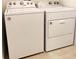 This laundry room has a Whirlpool washer and dryer set ready to wash those clothes at 1613 Pelican Dr, Davenport, FL 33896