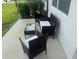 Outdoor patio with wicker furniture and a glass table, perfect for relaxing or entertaining at 1613 Pelican Dr, Davenport, FL 33896