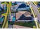 Aerial view of a home highlighting its pool, patio, screened enclosure, roof, and landscaping at 1737 Caribbean View Ter, Kissimmee, FL 34747