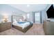 Serene bedroom with a king bed, stylish decor, and ample natural light, creating a peaceful retreat at 1737 Caribbean View Ter, Kissimmee, FL 34747