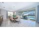 Dining room with elegant lighting, slider doors to outdoor living space, and a view of the pool at 1737 Caribbean View Ter, Kissimmee, FL 34747