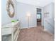 Bright hallway with stylish decor, a decorative mirror, and a glimpse into a comfortable living space at 1737 Caribbean View Ter, Kissimmee, FL 34747