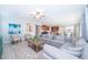 Comfortable living room featuring a sectional sofa, stylish decor and an open layout to the kitchen at 1737 Caribbean View Ter, Kissimmee, FL 34747