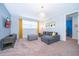 Cozy living room features a comfortable gray sectional, stylish ottoman, and a wall-mounted TV for relaxed living at 1737 Caribbean View Ter, Kissimmee, FL 34747