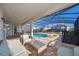 Screened-in pool area with comfortable seating, a spa, and a covered patio, perfect for relaxation at 1737 Caribbean View Ter, Kissimmee, FL 34747