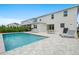 Resort-style backyard with pool, patio dining, lounge chairs, grill and lush landscaping is great for entertaining at 194 Golden Noble St, Davenport, FL 33897
