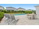 Backyard with a pool, patio furniture, grill, and privacy landscaping offers a relaxing outdoor space at 194 Golden Noble St, Davenport, FL 33897