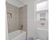 A well-lit bathroom including a shower-tub combo, a toilet, and vanity with neutral finishes at 194 Golden Noble St, Davenport, FL 33897
