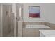 This spacious bathroom has double sinks, a separate soaking tub and a glass enclosed shower at 194 Golden Noble St, Davenport, FL 33897
