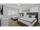 Bright bedroom featuring two queen beds, neutral décor, and bright natural light streaming through the windows at 194 Golden Noble St, Davenport, FL 33897