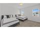 Well-lit bedroom with two twin beds, neutral décor, and bright natural light streaming through the windows at 194 Golden Noble St, Davenport, FL 33897