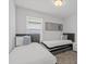 Bedroom featuring two beds with decorative pillows and a large window at 194 Golden Noble St, Davenport, FL 33897