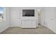 Neutral-toned bedroom with a large TV over a dresser, two closets, and bright natural light at 194 Golden Noble St, Davenport, FL 33897