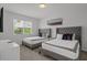 Comfortable bedroom with two twin beds, neutral decor, and ample natural light from the window at 194 Golden Noble St, Davenport, FL 33897