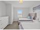 This bedroom is well-lit, featuring two beds, a dresser, and a window at 194 Golden Noble St, Davenport, FL 33897