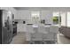 Modern kitchen showcasing stainless steel appliances, island seating and open layout at 194 Golden Noble St, Davenport, FL 33897