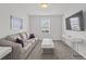 Comfortable living room with a plush sofa, modern coffee table, and mounted TV at 194 Golden Noble St, Davenport, FL 33897