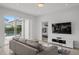 Cozy living room with sliding glass doors leading to a pool and patio area at 194 Golden Noble St, Davenport, FL 33897