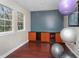 Bright exercise room with hardwood floors, natural light, and workout equipment for a comfortable fitness area at 19934 Villa Isle # 107, Orlando, FL 32821