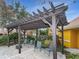 Covered pergola with comfortable seating, providing a shaded area for relaxation at 19934 Villa Isle # 107, Orlando, FL 32821