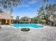 Large community pool surrounded by lounge chairs and lush landscaping, perfect for relaxation at 19934 Villa Isle # 107, Orlando, FL 32821