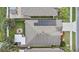 Home's roof with solar panels and outdoor firepit with seating in the backyard at 2559 Eagle Bay Blvd, Kissimmee, FL 34743