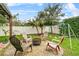 Lush backyard featuring a fire pit, swing set, and mature trees at 2559 Eagle Bay Blvd, Kissimmee, FL 34743