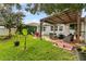 Spacious backyard featuring a covered patio, playground, and lush greenery at 2559 Eagle Bay Blvd, Kissimmee, FL 34743