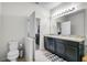 Bathroom featuring a double sink vanity with dark wood cabinets, light walls, and a toilet at 2559 Eagle Bay Blvd, Kissimmee, FL 34743