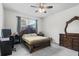 Spacious bedroom featuring a dark wood bed frame, desk, and dresser at 2559 Eagle Bay Blvd, Kissimmee, FL 34743