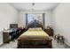 Bedroom with a dark wood bed frame, desk, and large window at 2559 Eagle Bay Blvd, Kissimmee, FL 34743