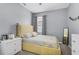 This bedroom boasts soft gray walls, neutral carpet, and a striking yellow bed frame and bedding at 2559 Eagle Bay Blvd, Kissimmee, FL 34743
