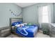 Bedroom with a blue video game themed comforter, a window with curtains, and a grey dresser at 2559 Eagle Bay Blvd, Kissimmee, FL 34743