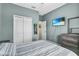 Bedroom featuring light walls, a grey dresser, a mounted TV, and a closet with white double doors at 2559 Eagle Bay Blvd, Kissimmee, FL 34743