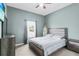 Bedroom featuring light gray walls, a queen bed, a window with blinds, and a gray dresser at 2559 Eagle Bay Blvd, Kissimmee, FL 34743