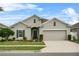 Charming single Gathering home with a two car garage, manicured lawn and beautiful flowerbeds at 2559 Eagle Bay Blvd, Kissimmee, FL 34743